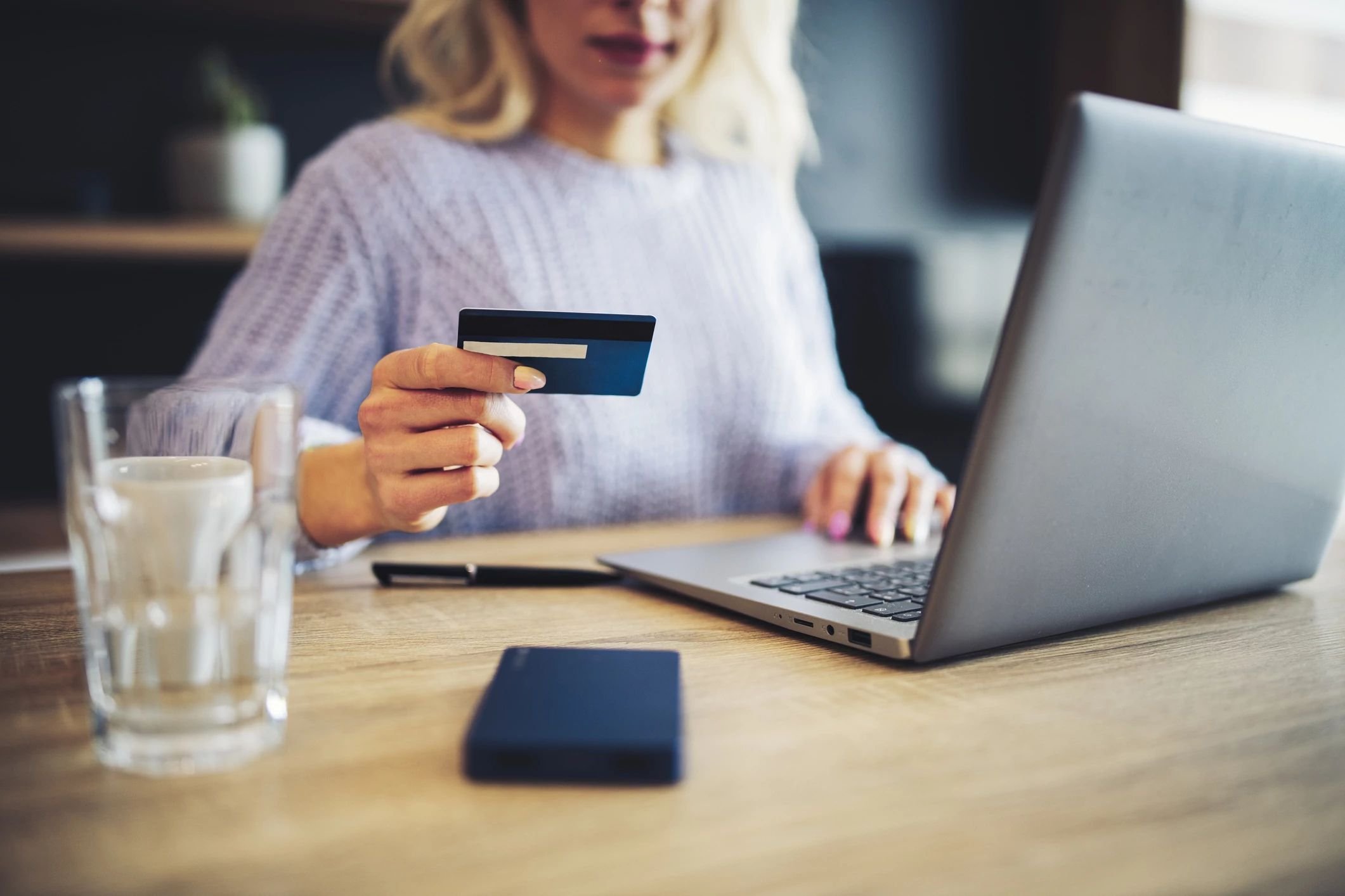 woman holding credit card - J&J Carpets LLC in GA